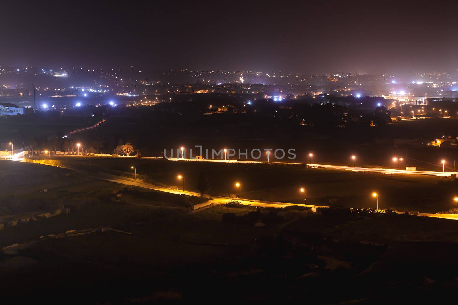 Night panorama view of illuminated roads and grounds around Mdina - old capital of Malta. Shooted with long exposure.