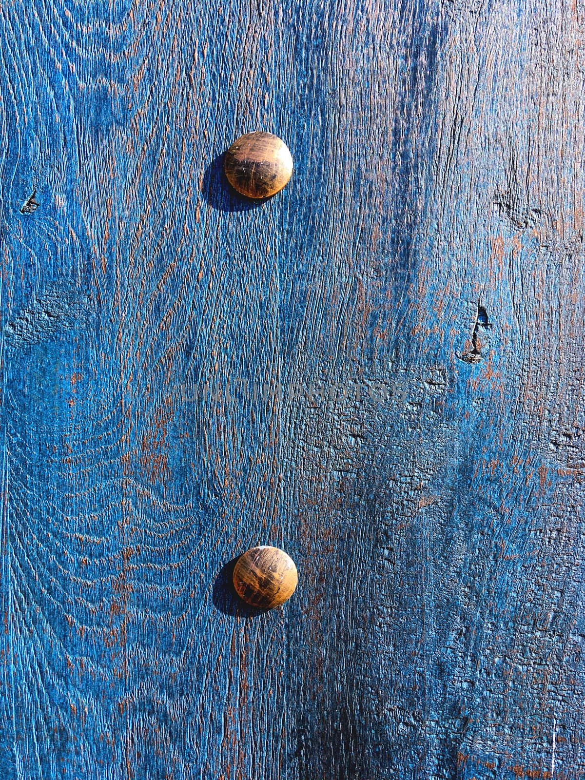 Classic blue wooden background of old door with metal details.