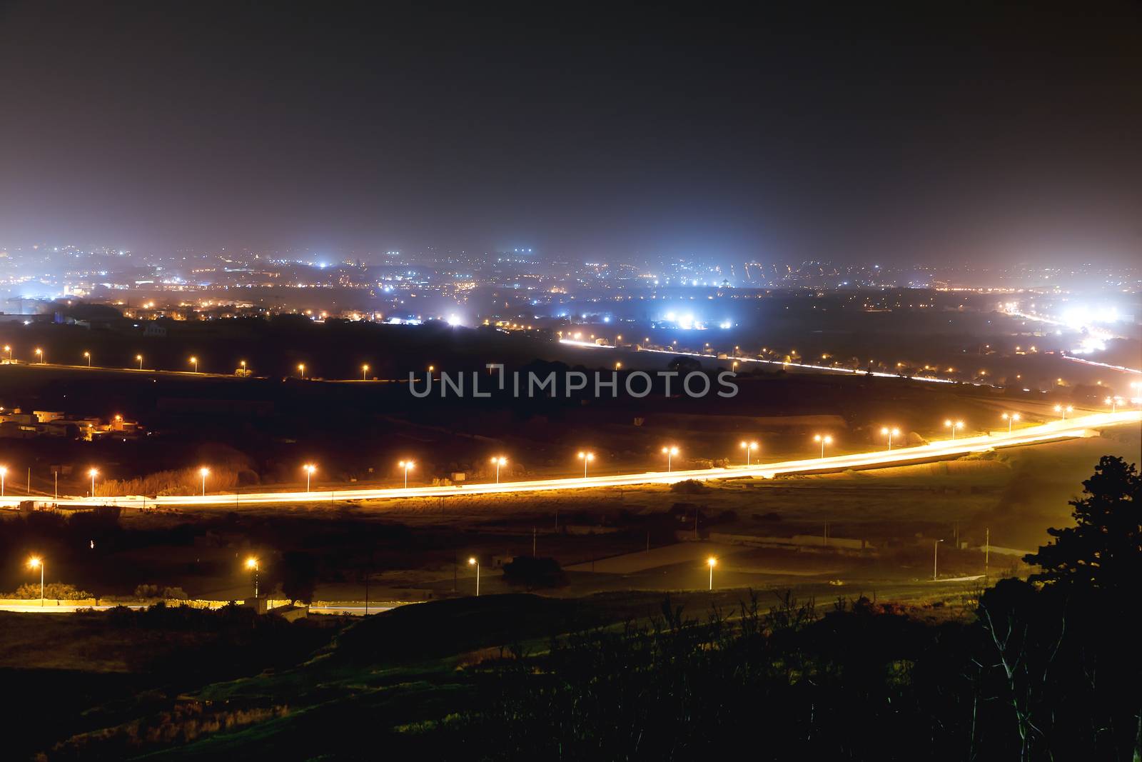 Night panorama view of illuminated roads and grounds around Mdina - old capital of Malta. Shooted with long exposure.