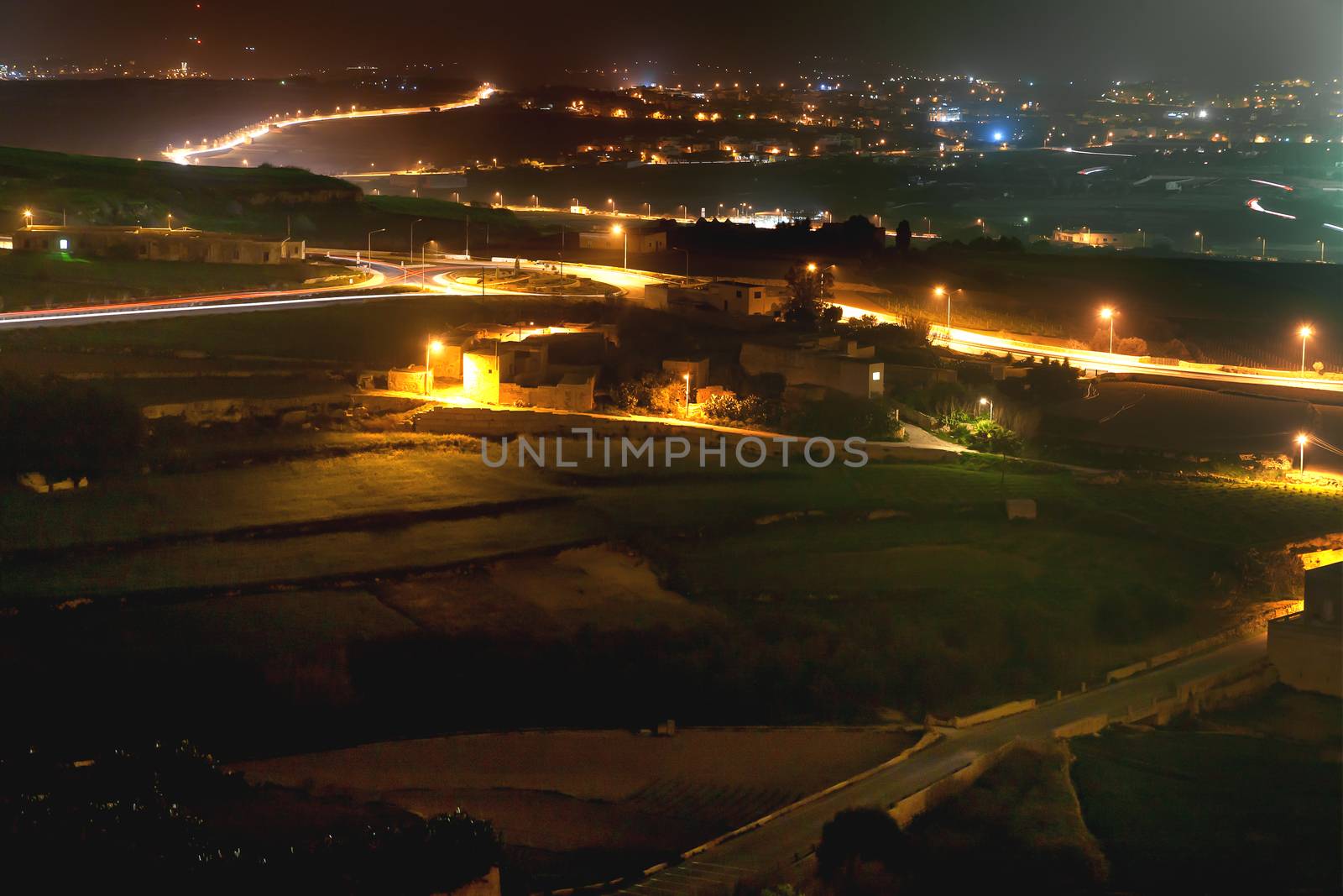 Night panorama view of illuminated roads and grounds around Mdina - old capital of Malta. Shooted with long exposure. by aksenovko