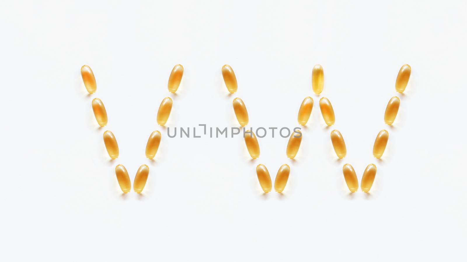 Letters V, W made of transparent yellow pills. Part 8 of latin alphabet in medical style. Isolated on white background.