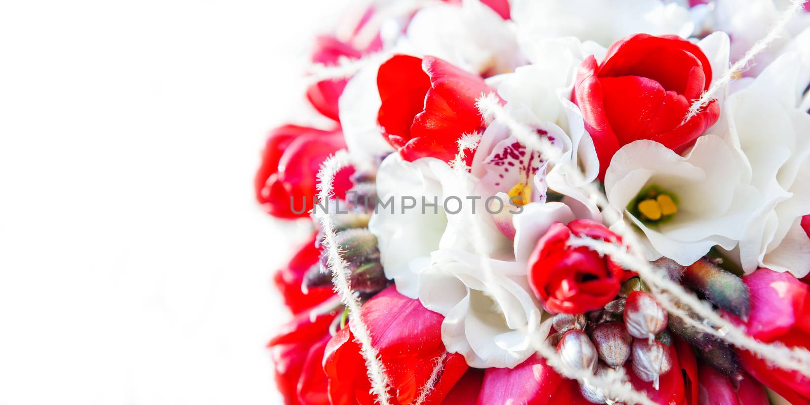 Bridal bouquet on sunlight. Traditional floral composition with bright red tulips. Background with copy space.