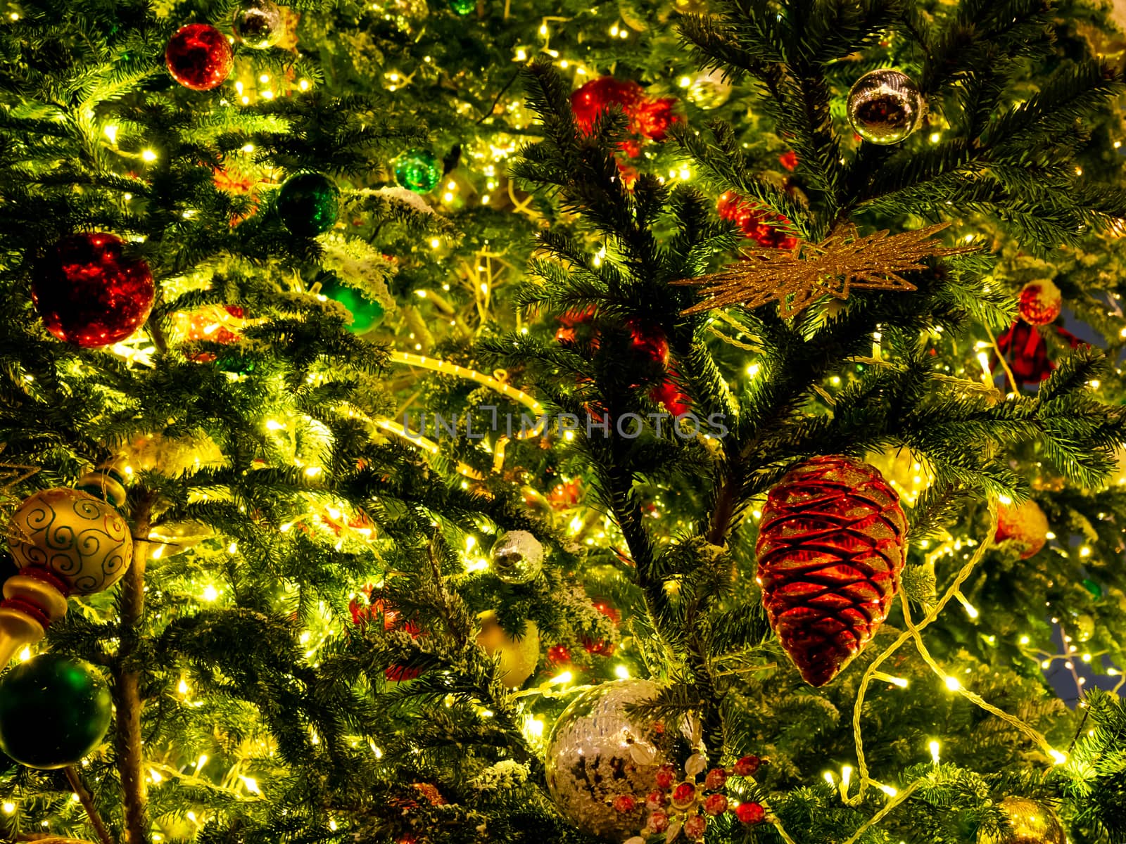 Decorative red pine cones on Christmas tree on Manezhnaya square in Moscow, Russia. Decorated fir tree for New Year celebration.