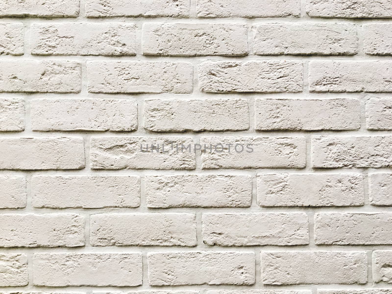 Outdoor wall made of white bricks. Stone texture of building wall.