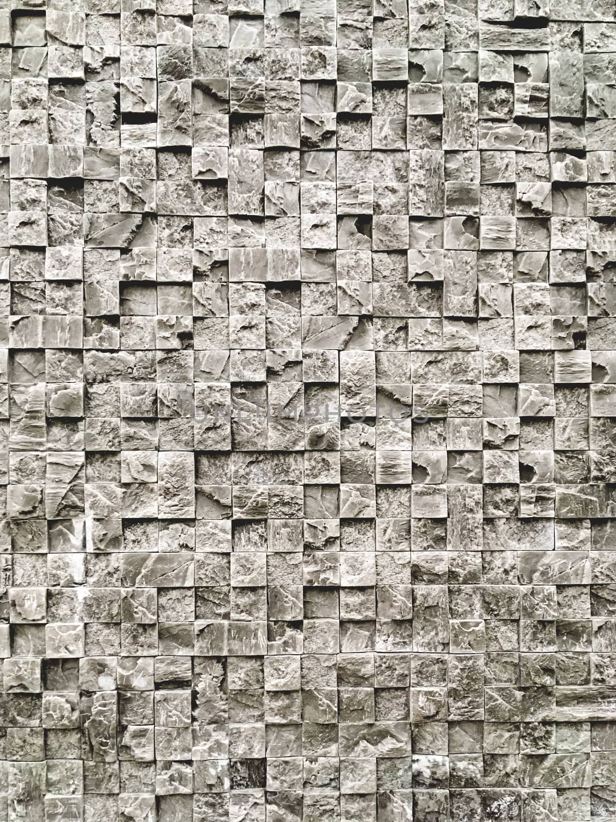 Outdoor wall made of grey decorative stones. Stone texture of building wall.