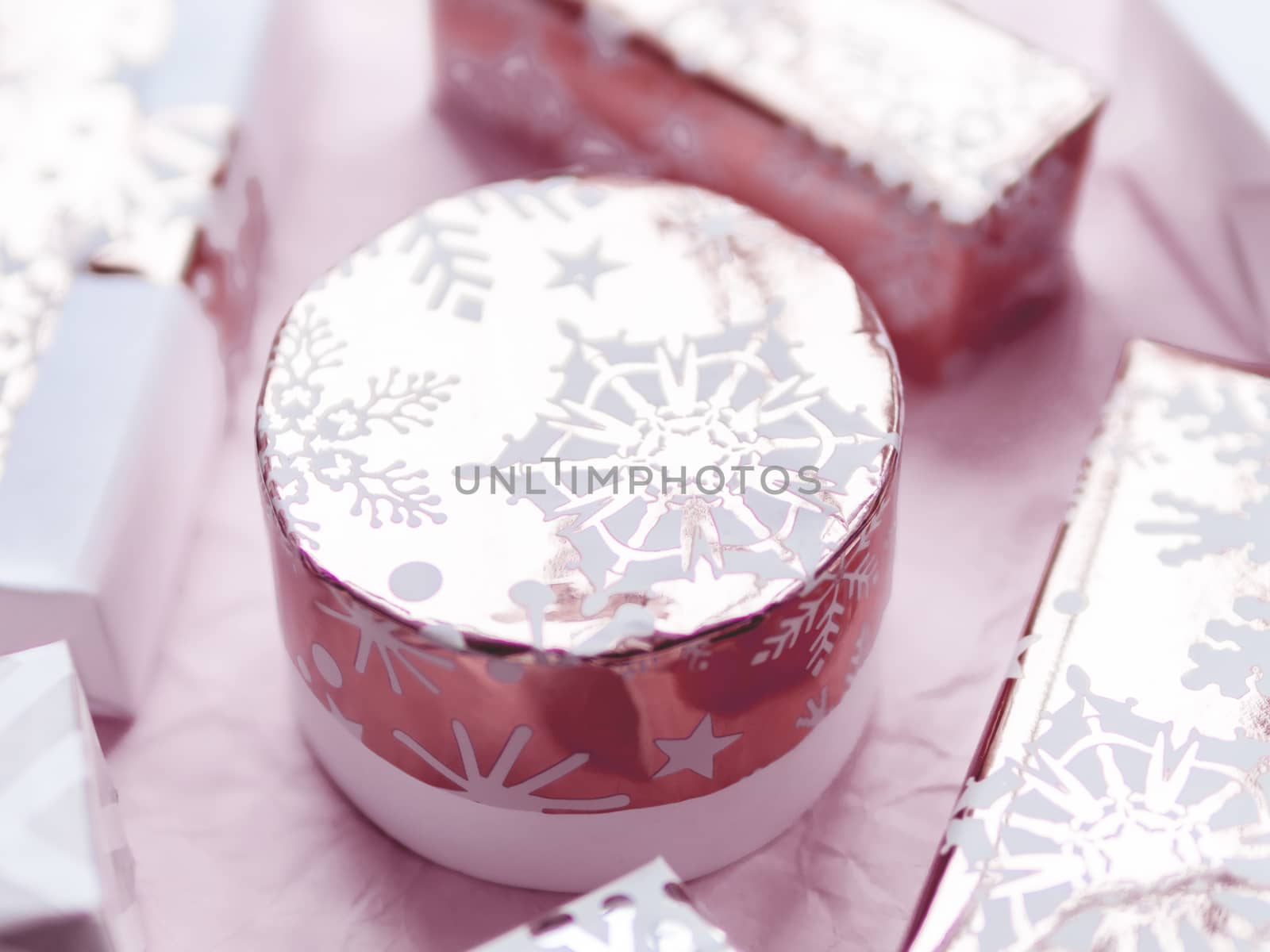 Valentine's Day presents with golden snowflakes. Gift boxes on lilac crumpled paper background.