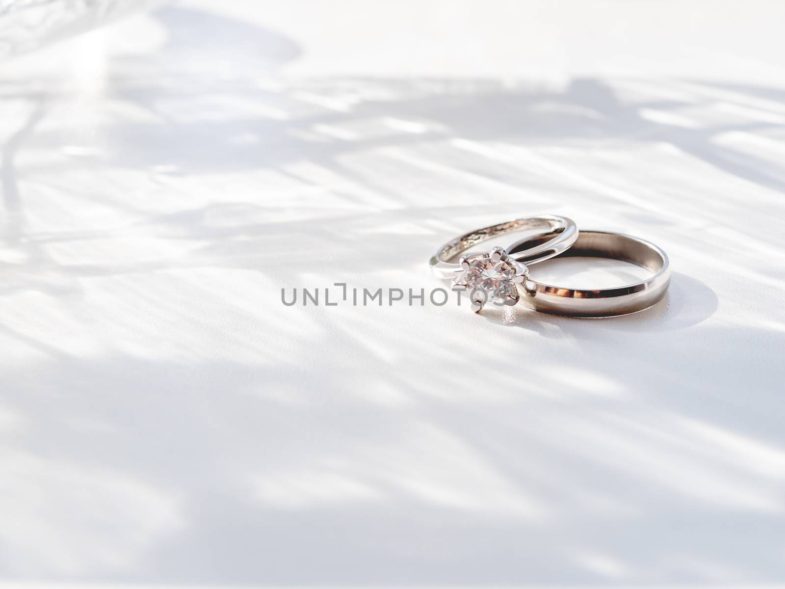 Wedding and engagement rings with diamond. Symbol of love and marriage on white background.