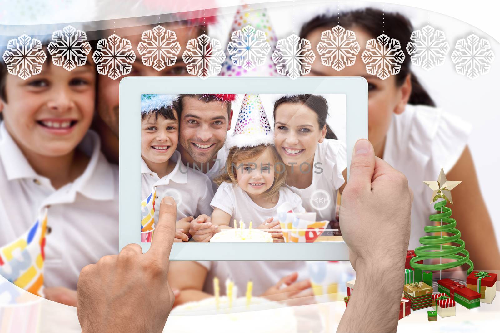 Hand holding tablet pc against snowflake frame