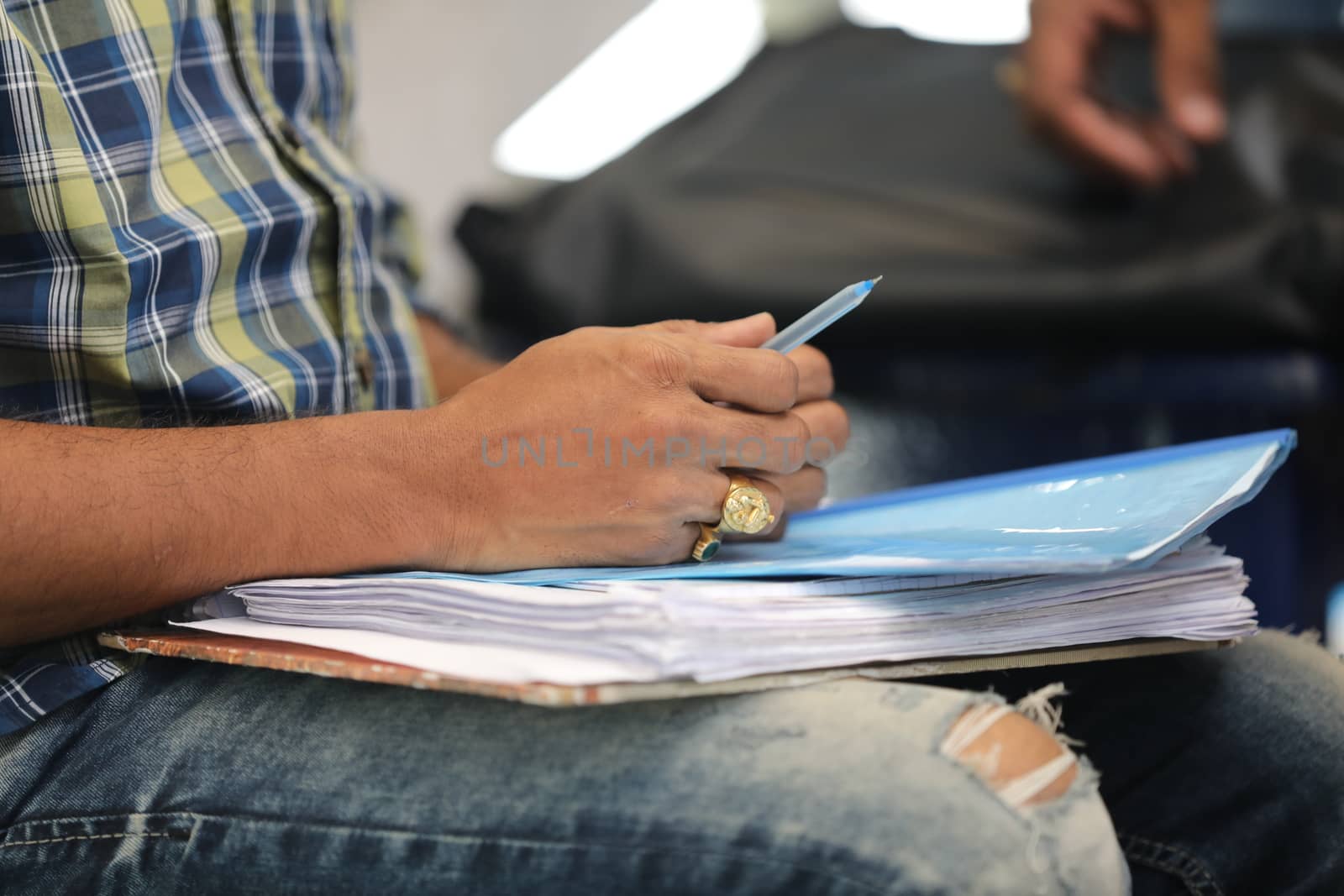 Male Hand with pen and papers