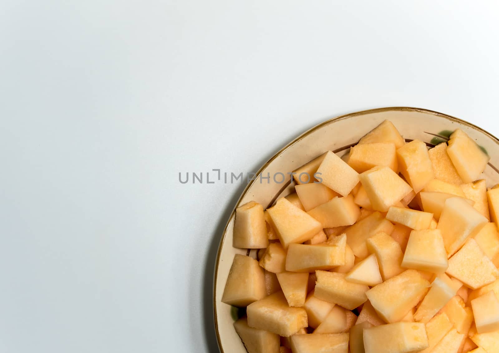 Small pieces of cantaloupe in the ceramic plate