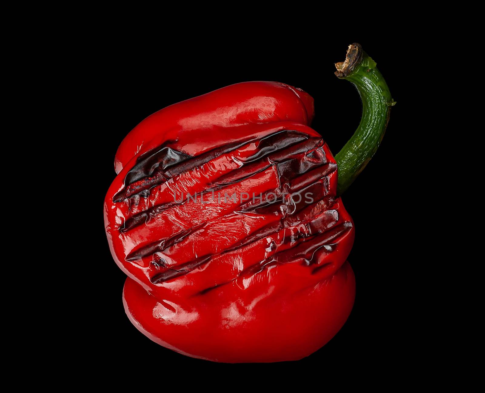 Grilled red pepper on black background. Paprika.