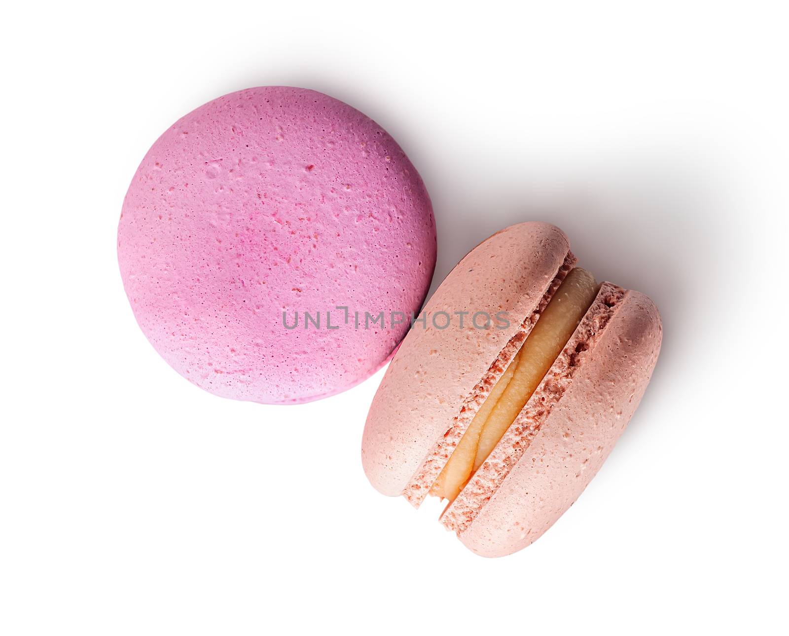 Two macaroon pink beige top view on white background