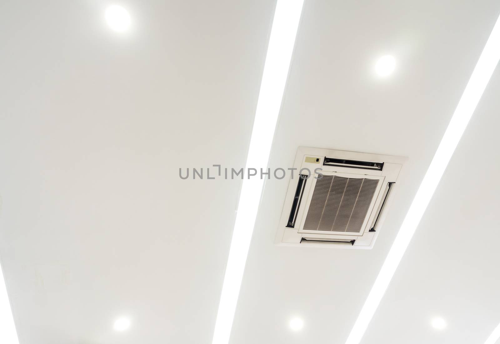 Lighting and ceiling mounted air conditioner on the modern ceili by Satakorn