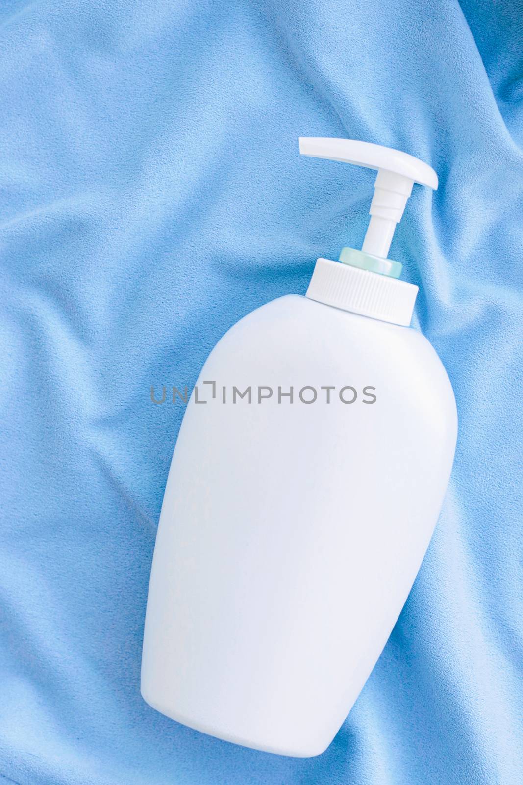 Blank label bottle of antibacterial liquid soap and hand sanitizer mockup on blue silk, hygiene product and health care by Anneleven