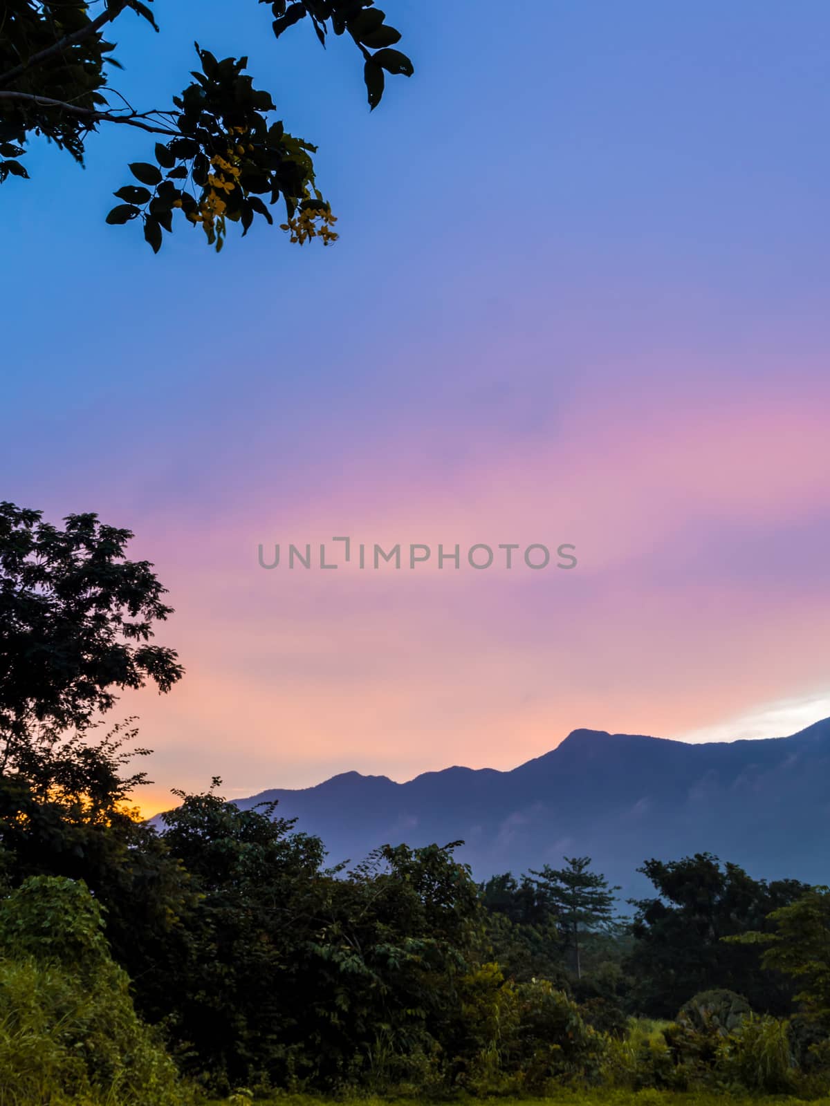 Colorful Sky and Clouds drifting over the forest mountain in eve by Satakorn