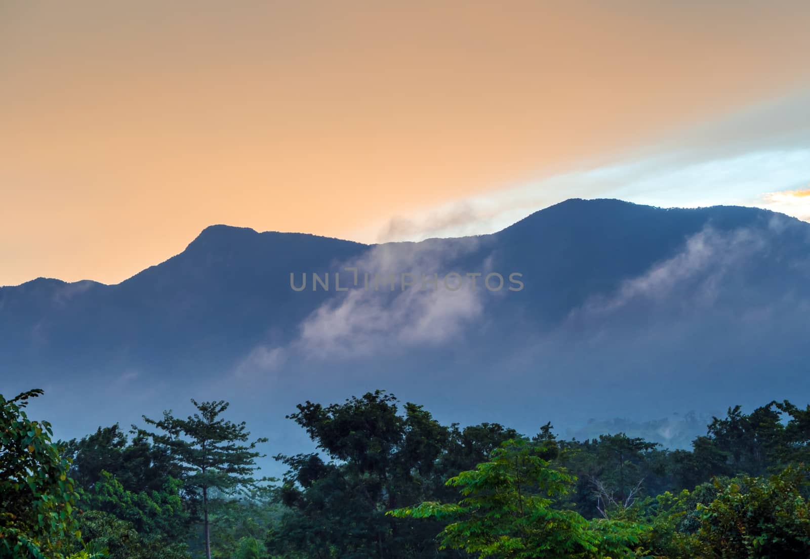 Colorful Sky and Clouds drifting over the forest mountain in eve by Satakorn