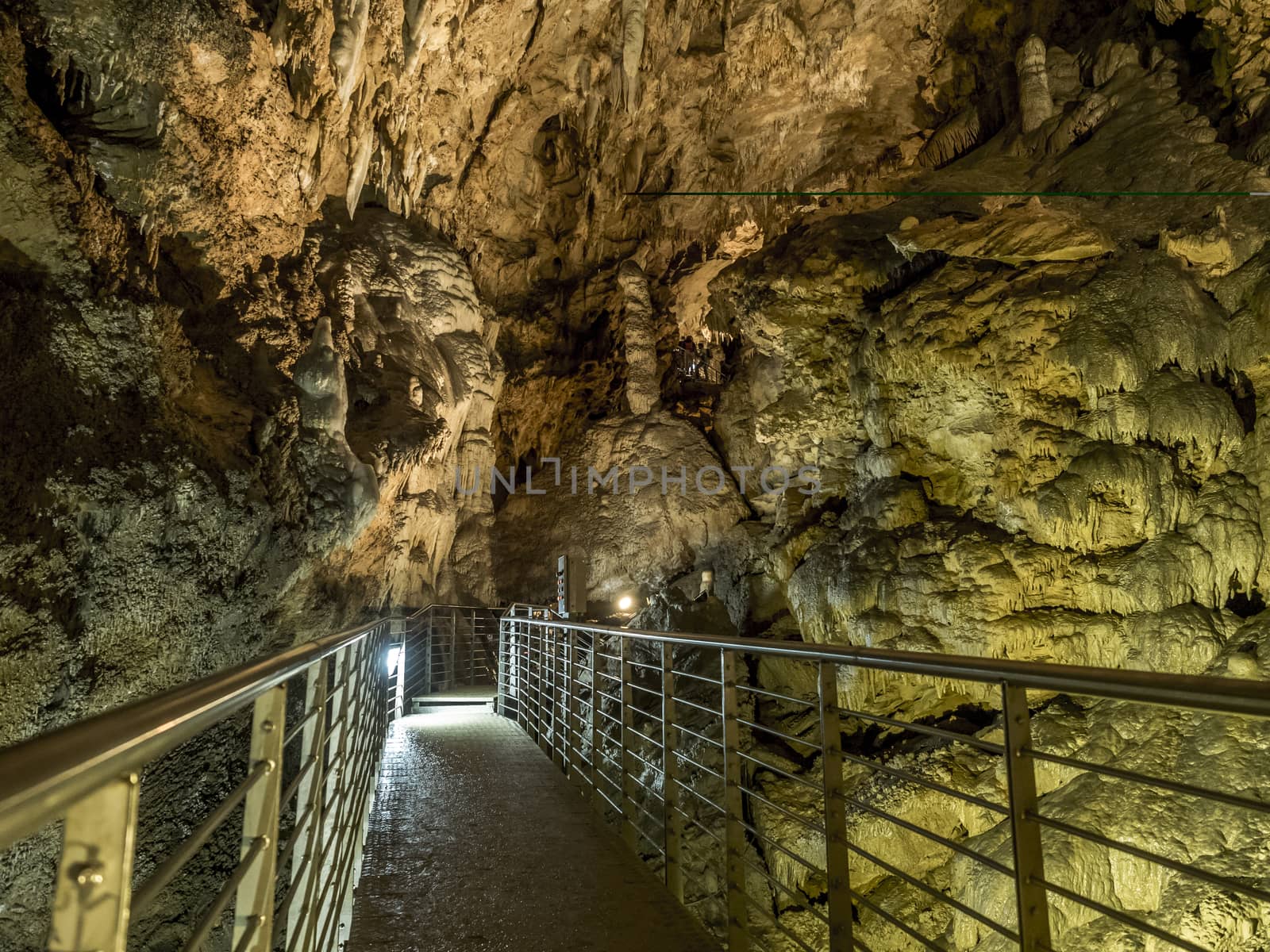 explores cave with stalagmites and stalactites