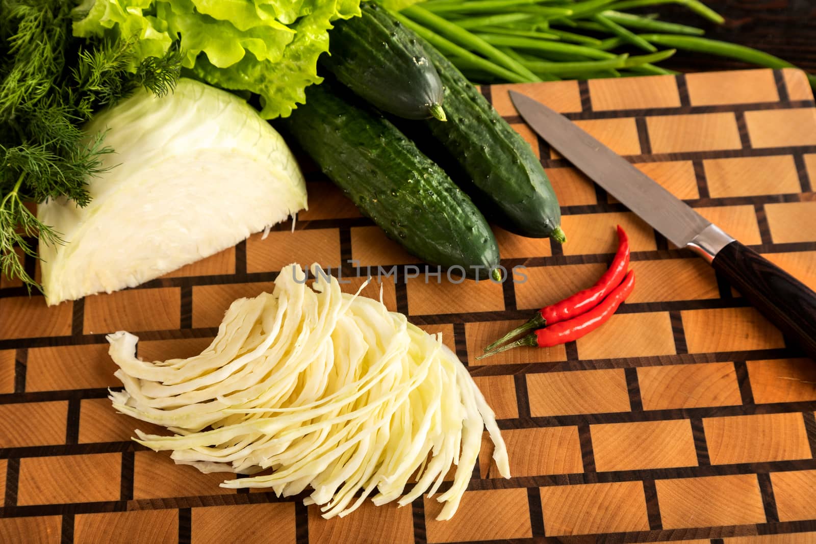 Knife vegetables and spices on a wooden cutting board