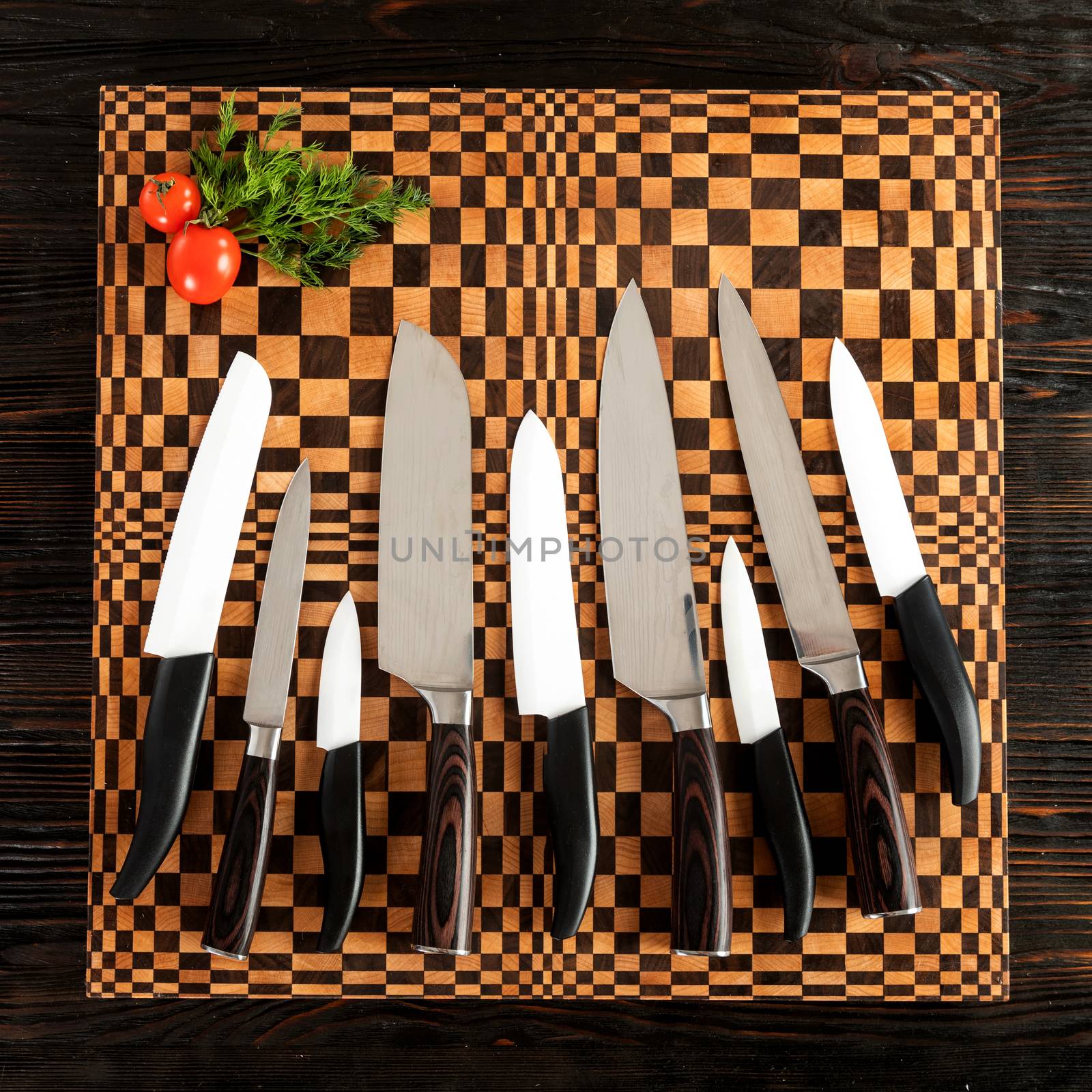 A set of high quality kitchen knives on a wooden cutting board