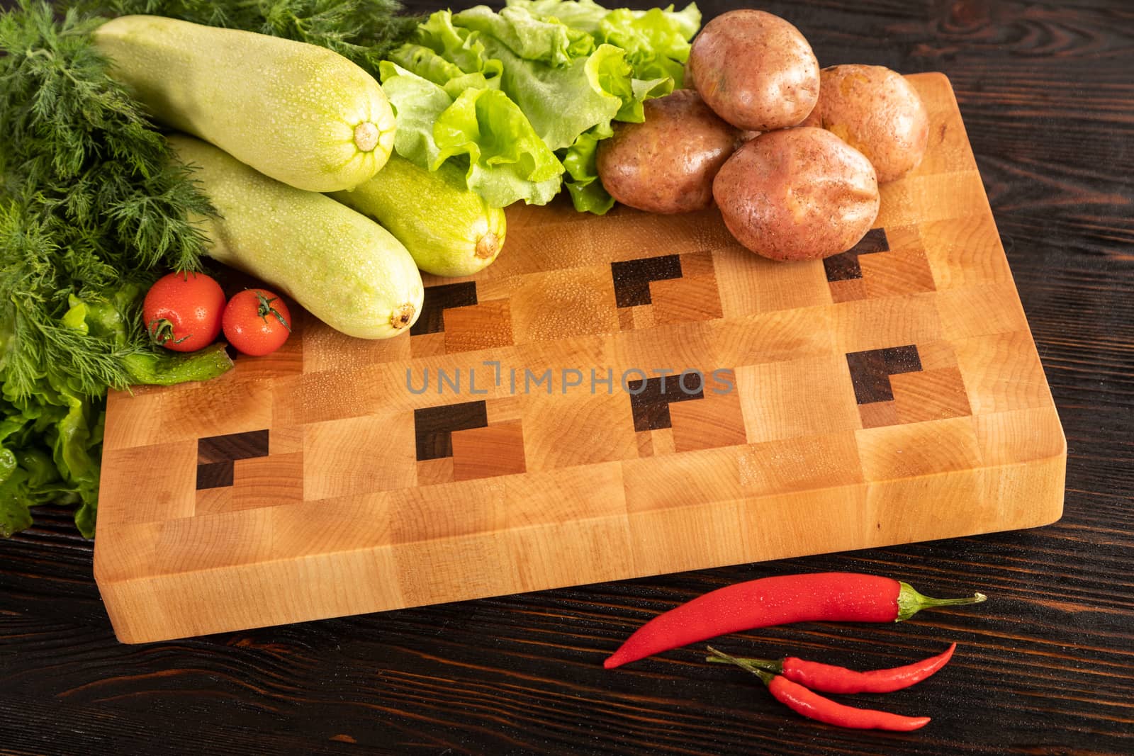 vegetables and spices on a wooden cutting board