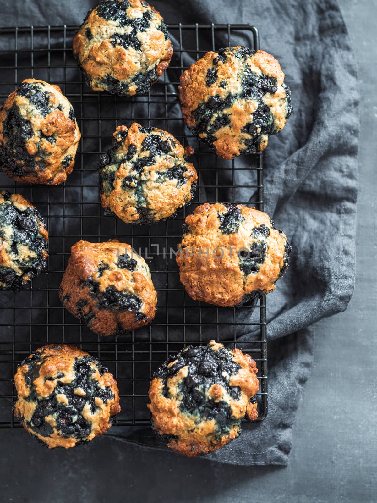 Homemade blueberry muffins on dark background. by fascinadora
