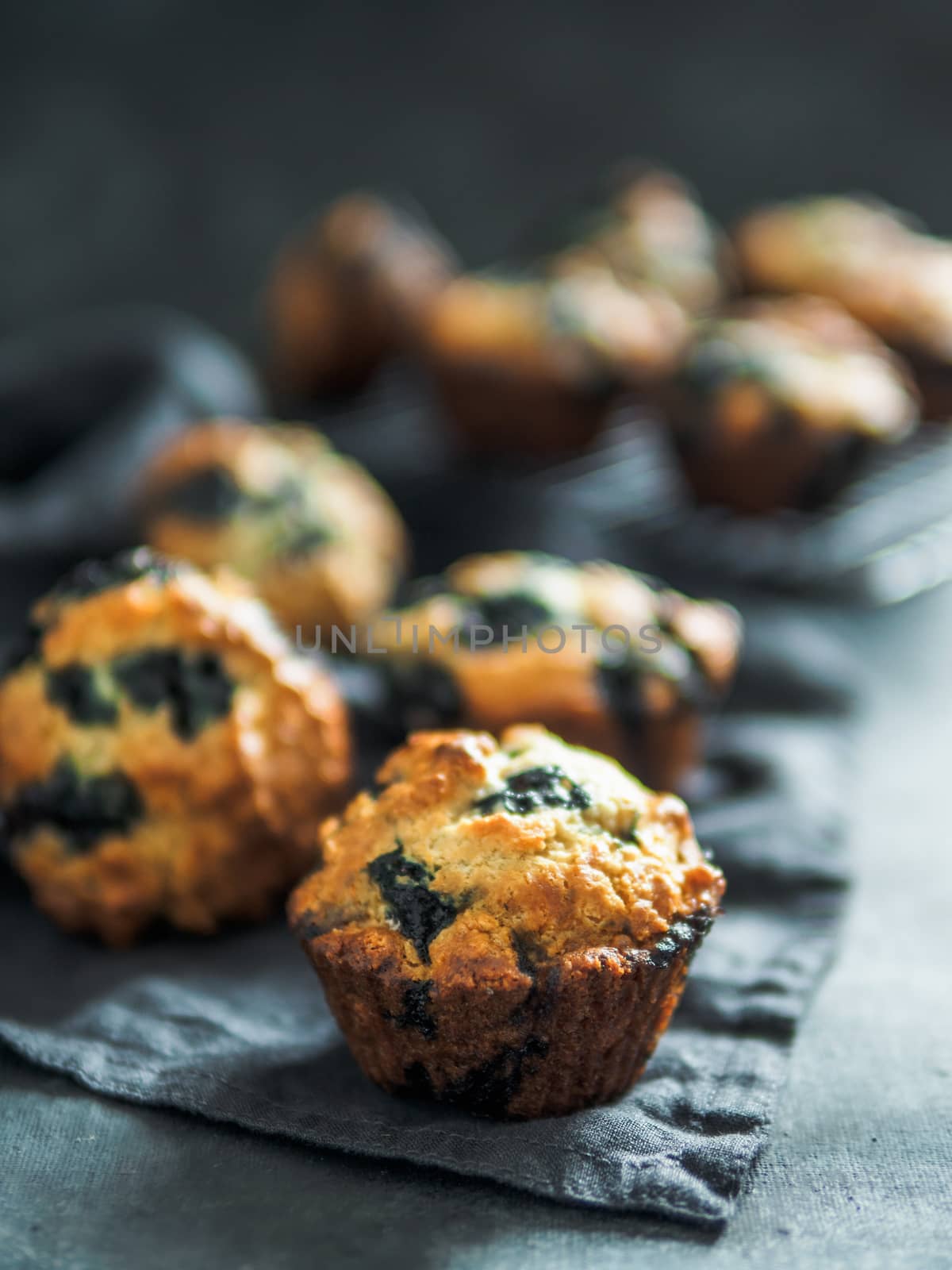 Homemade blueberry muffins on dark background. by fascinadora