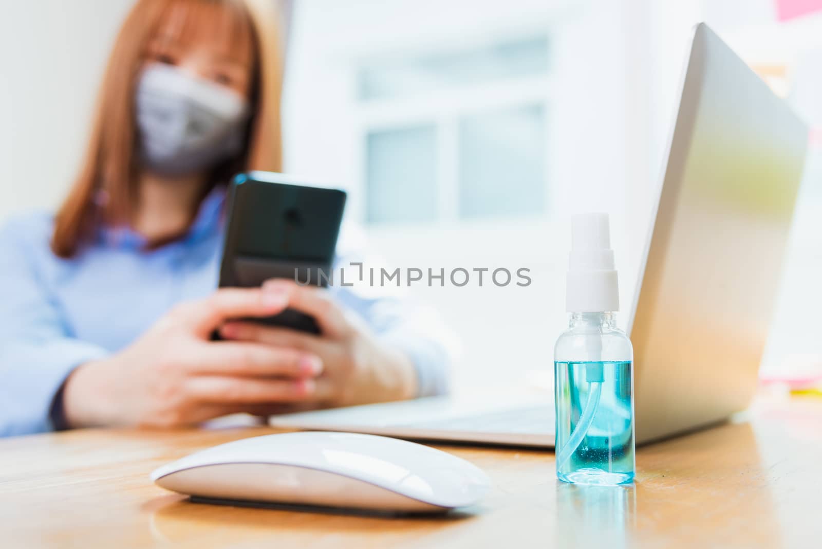 Business woman wearing face mask protective using smart mobile p by Sorapop