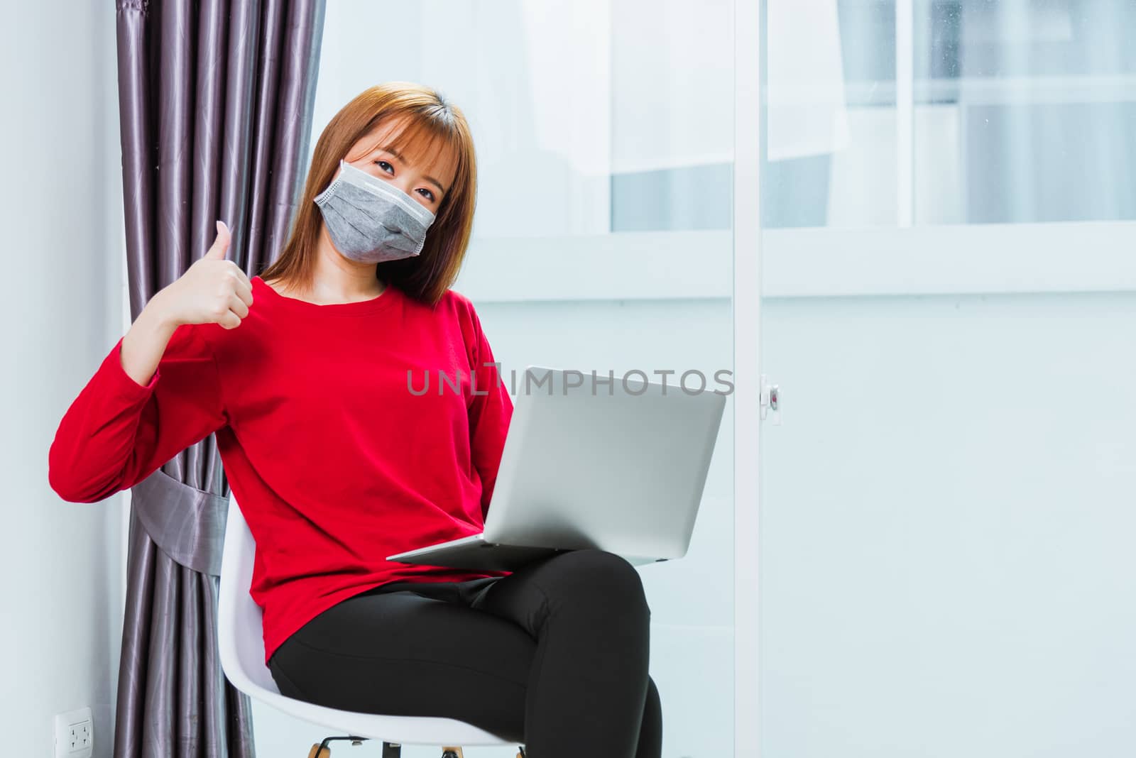 business woman sitting on chair wearing face mask protective wor by Sorapop