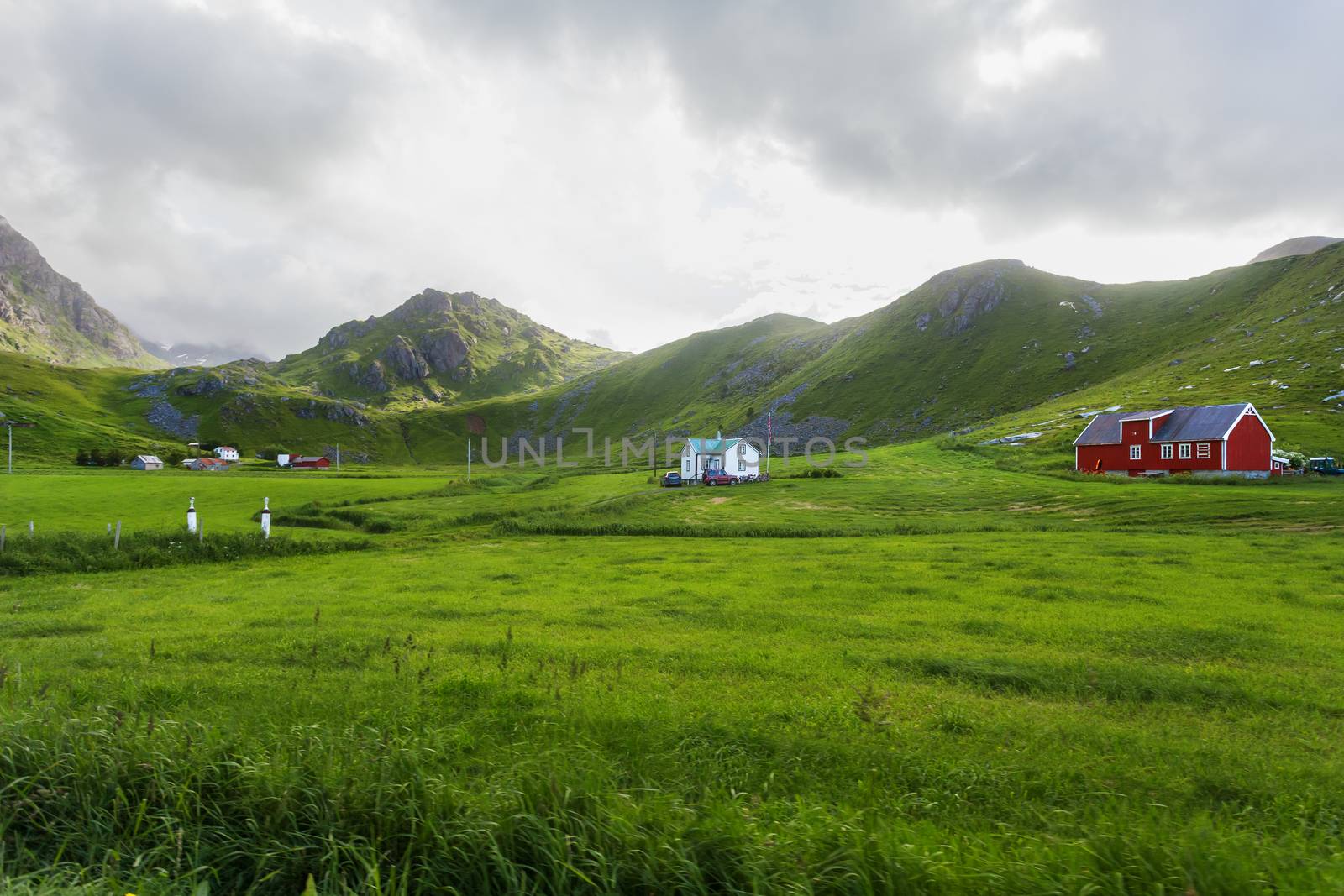 Beautiful scandinavian landscape with meadows, mountains and village. Lofoten islands, Norway.