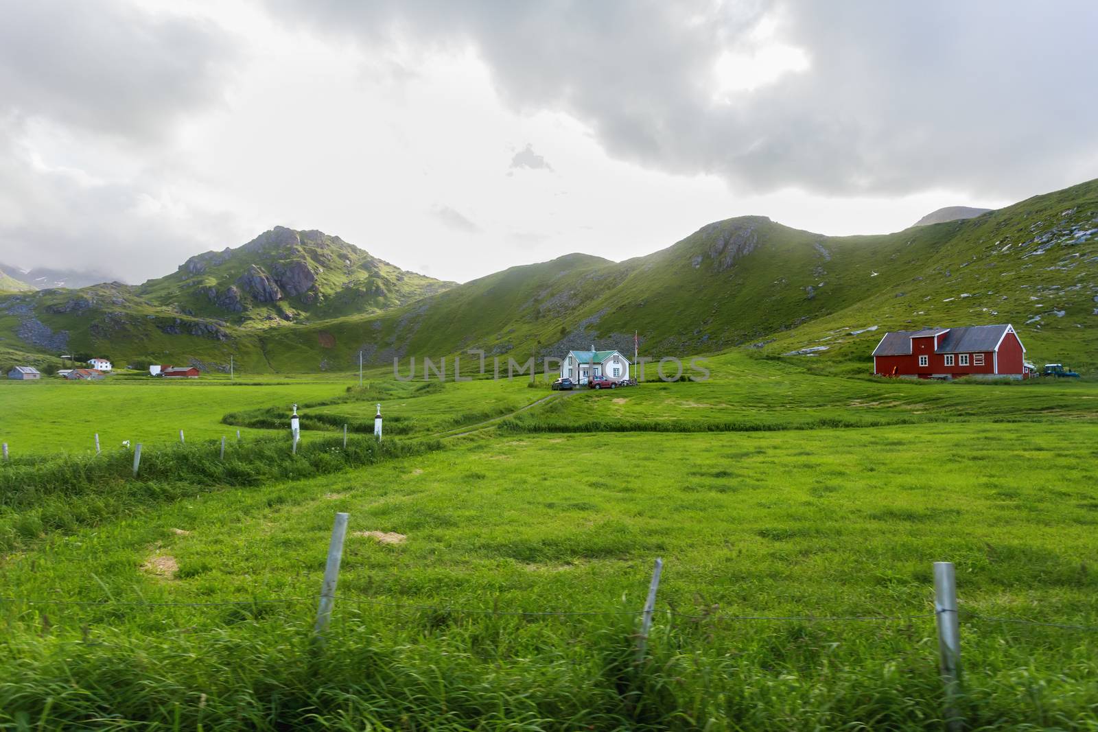 Beautiful scandinavian landscape with meadows, mountains and village. Lofoten islands, Norway.