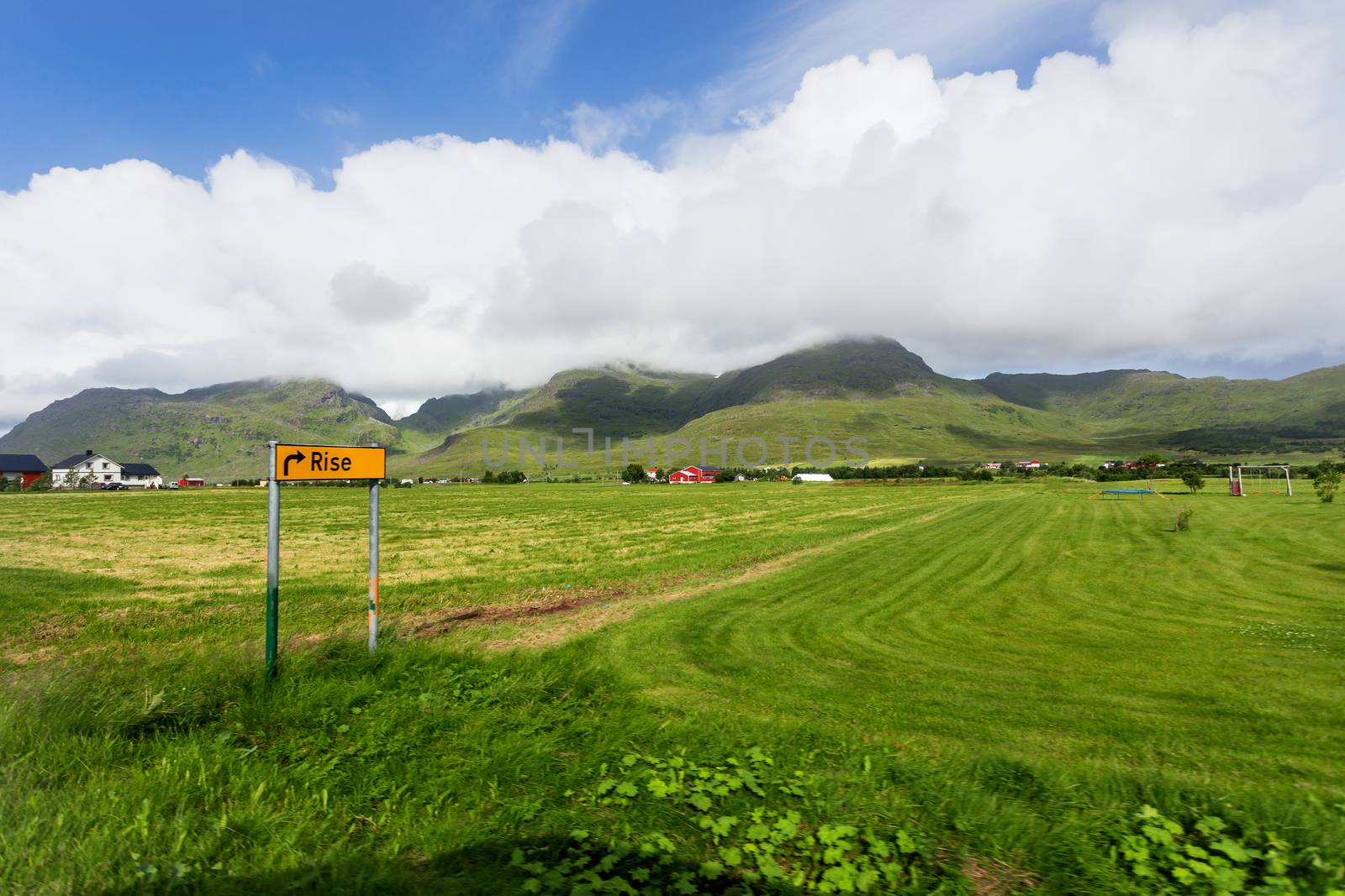 Typical scandinavian landscape with meadows, mountains and village. Rise, Lofoten islands, Norway.