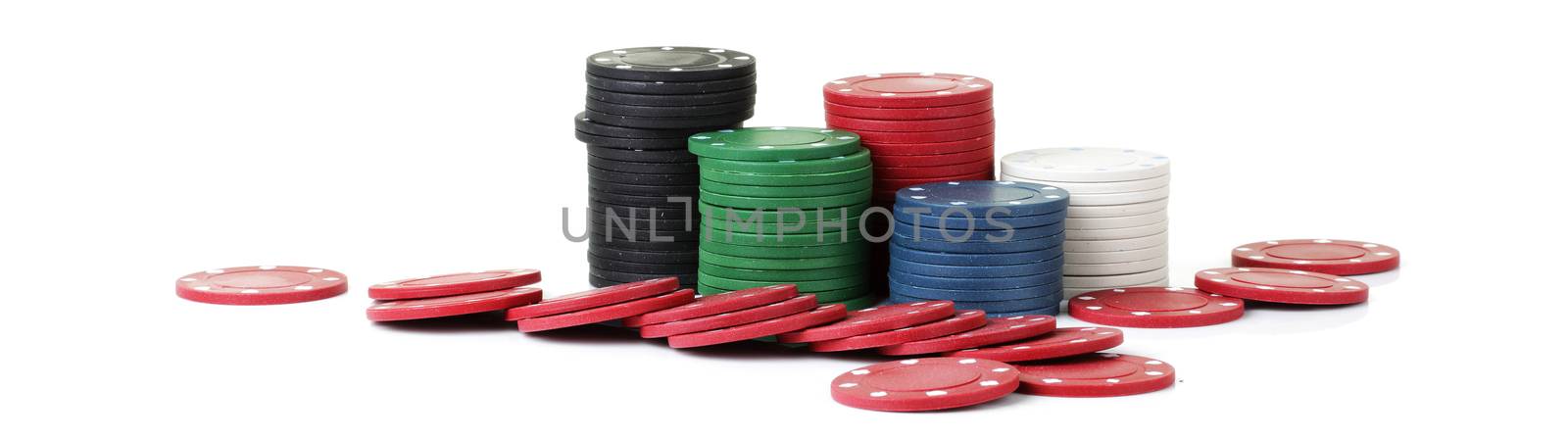 Piles of casino betting chips on white background