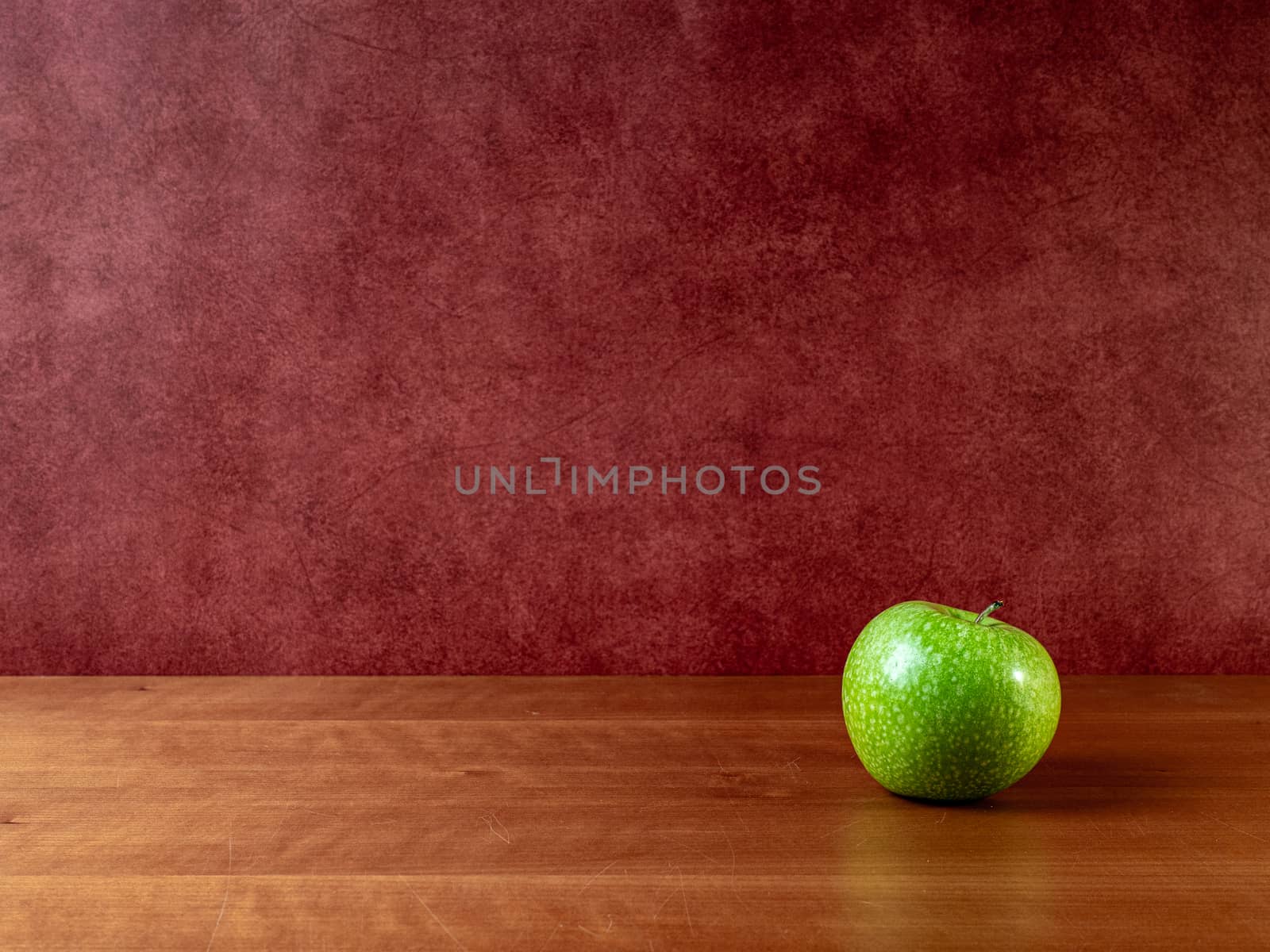 green apple on wooden table and eye background