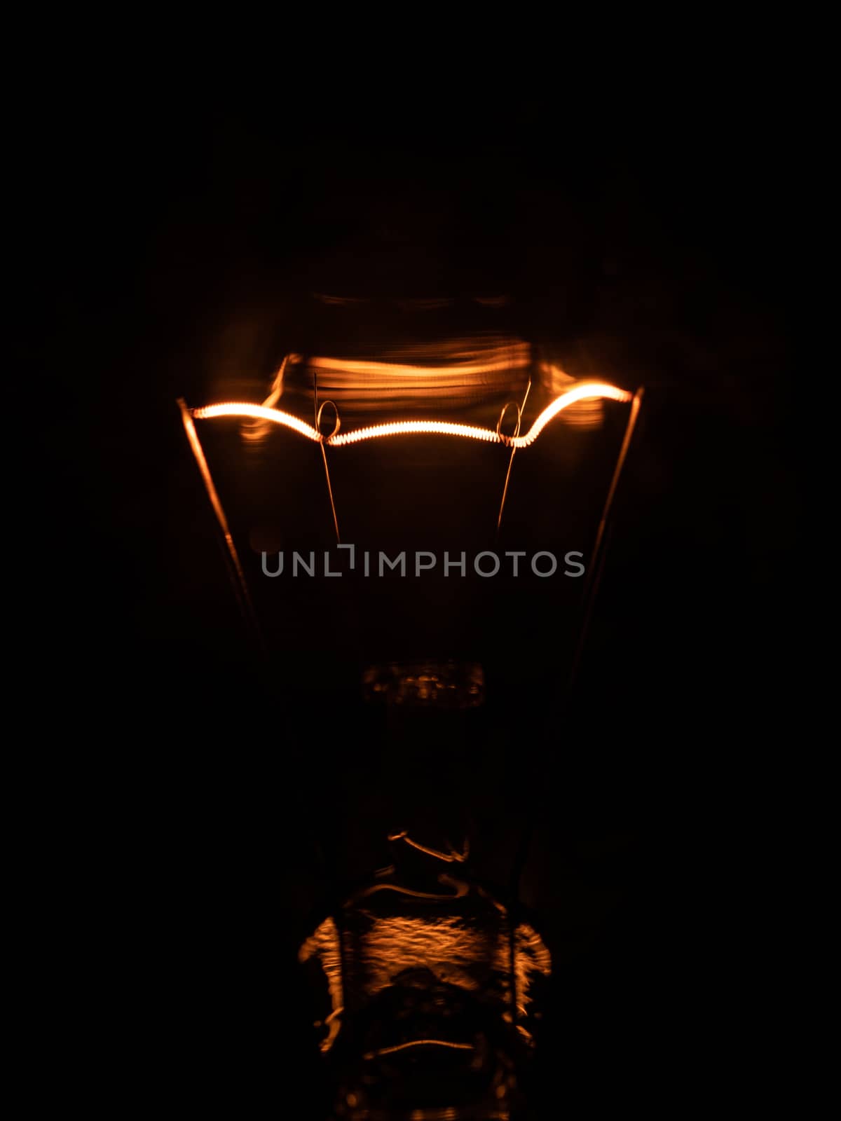 macro detail of light bulb with dark background