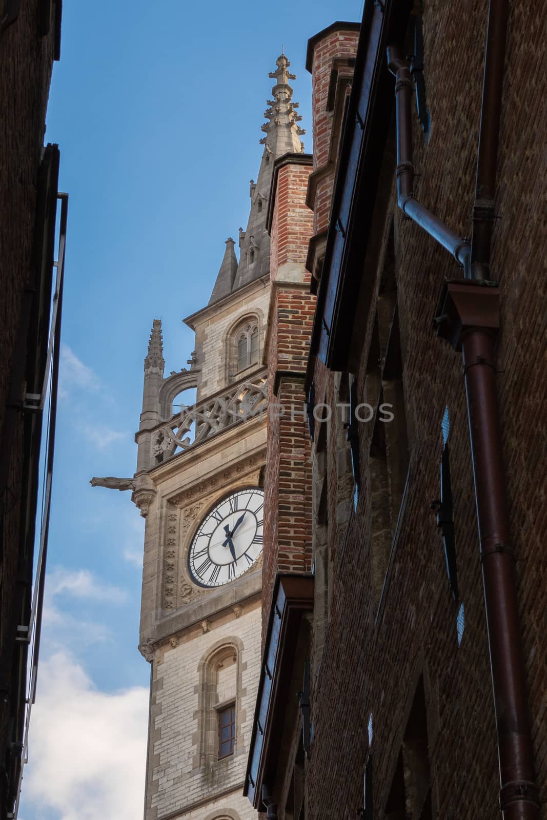 tower with clock on narrow street