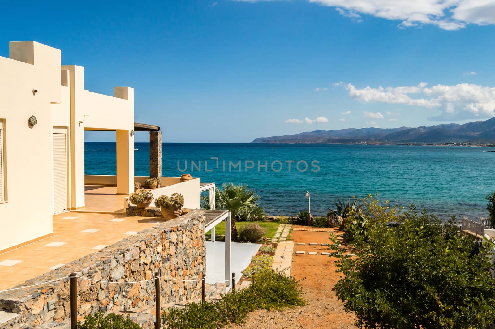 Bird's eye view from the street on a terrace of a beautiful Cretan sea beach in Crete