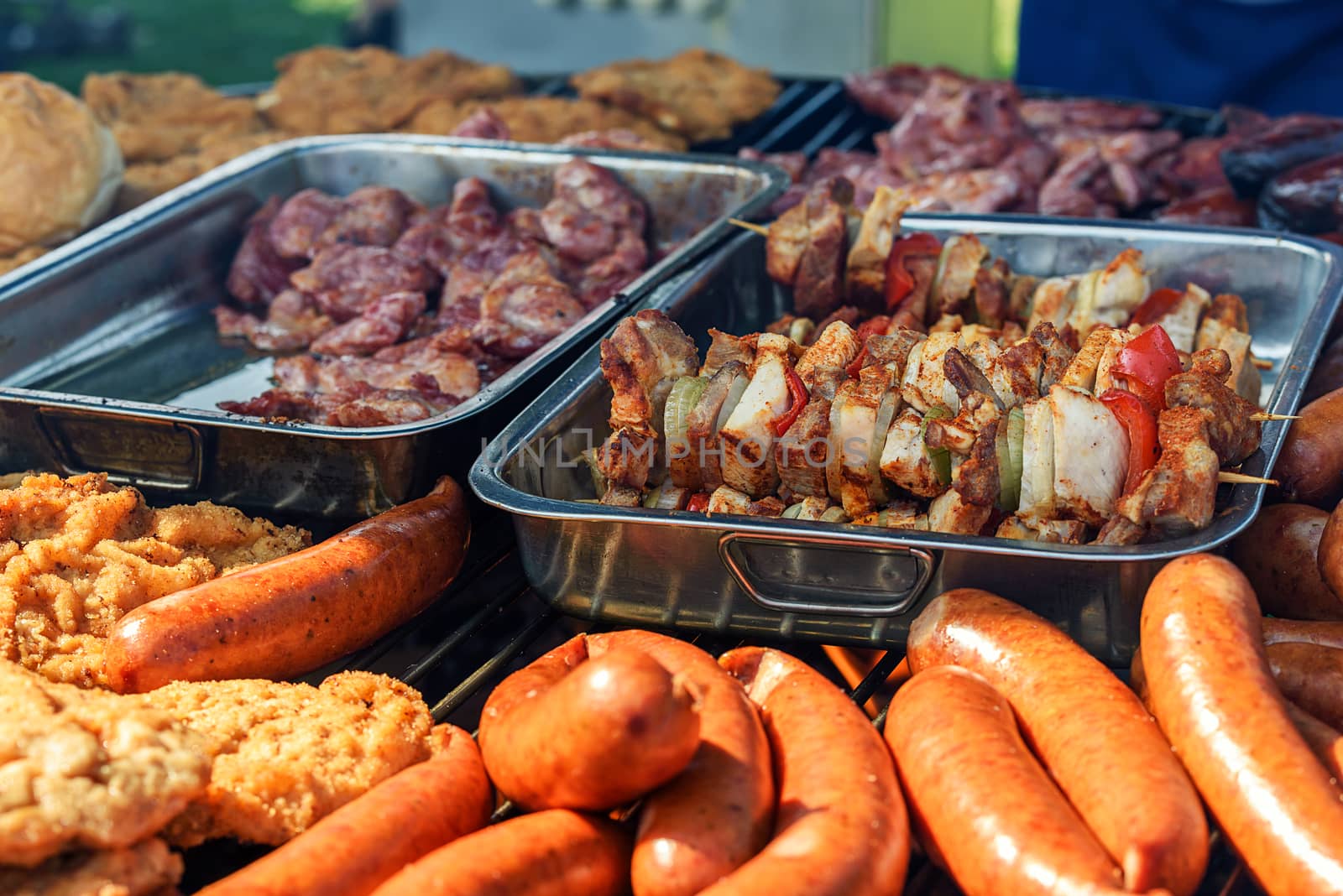 Different kinds of meat dishes on the barbeque during the party in the home garden.