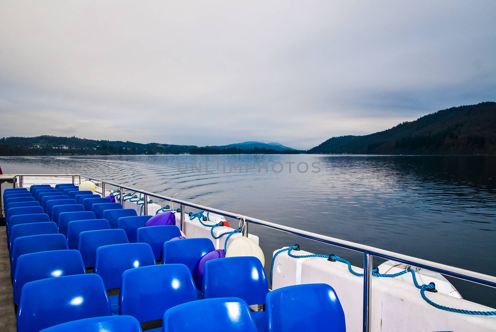 Rows of comfortable empty blue seats awaiting for passengers. UK