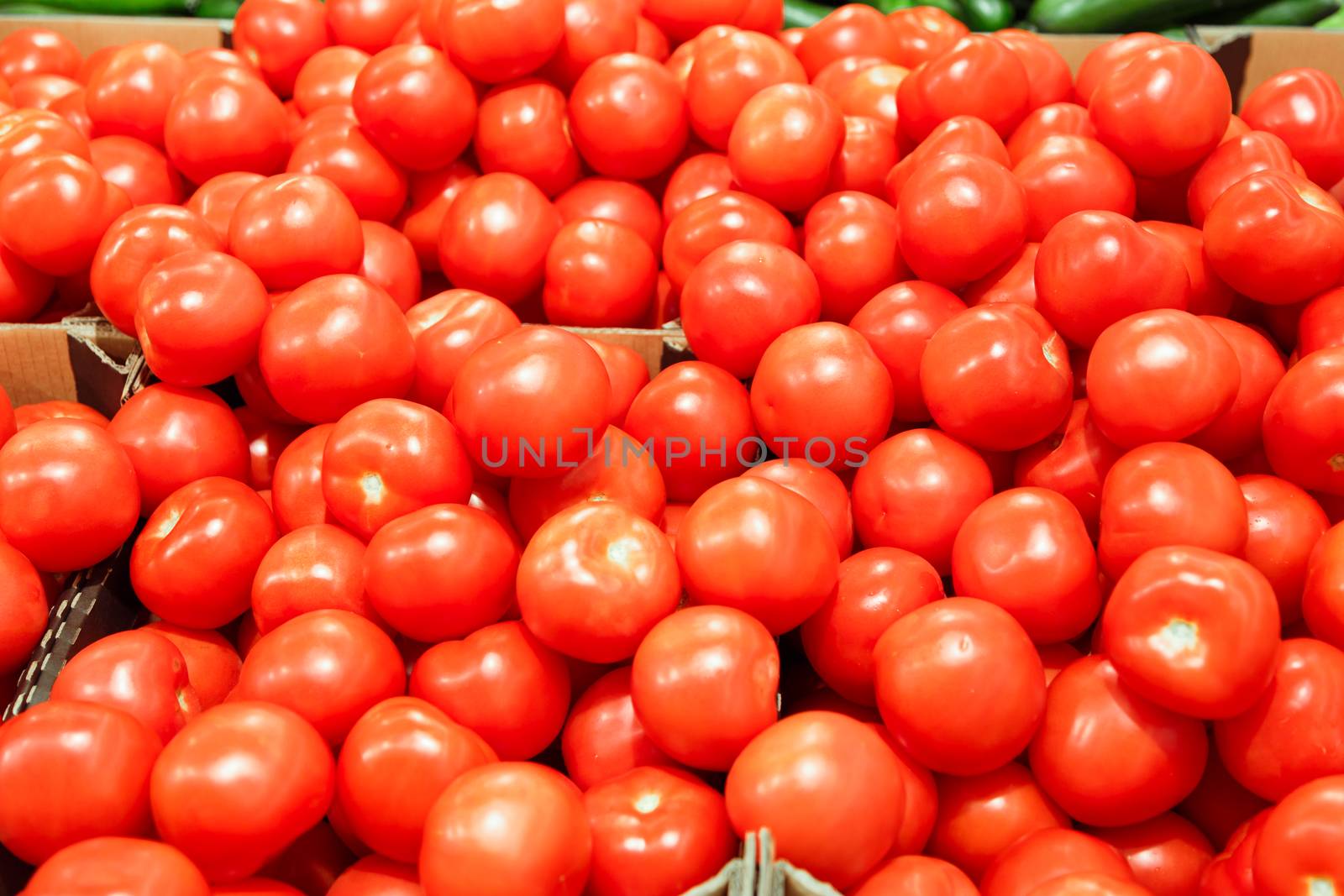 boxes with tomatoes in supermarket. Healthy Eating by vladdeep