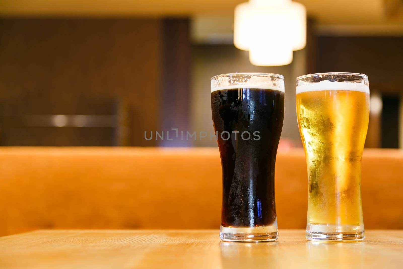 Two glasses of fresh cold beer. A glass  dark , the other light. by vladdeep