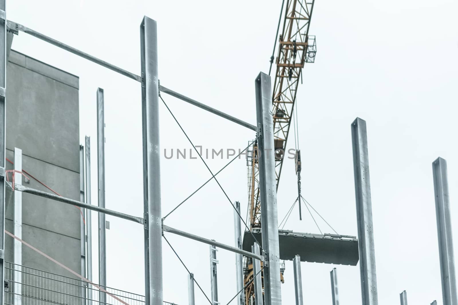 Generic construction site background with scaffolding on the building and crane.