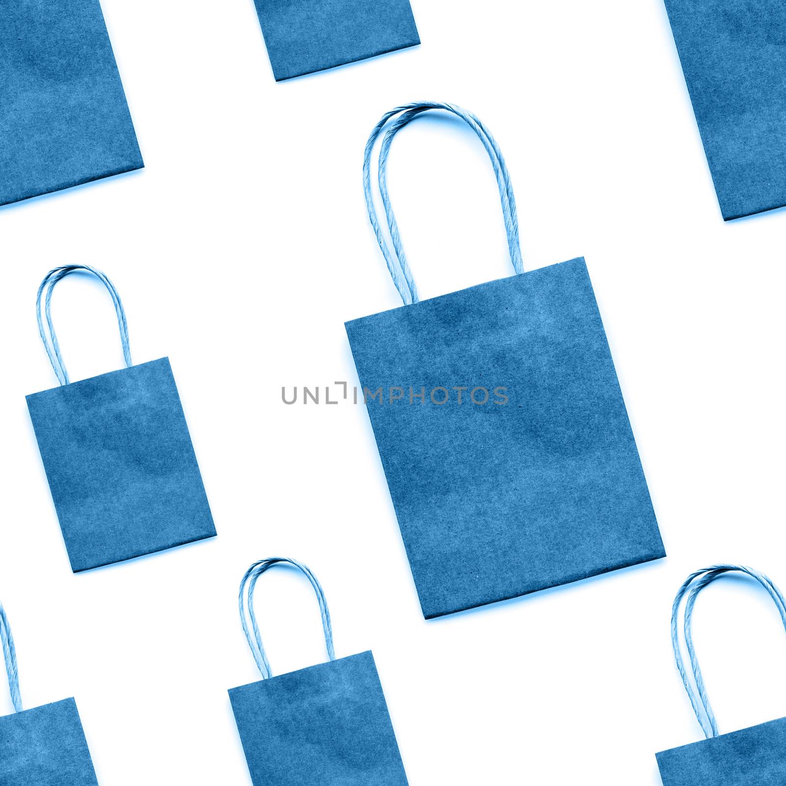 Photo seamless pattern with blue craft paper shopping bags. Zero waste lifestyle. Copy space.