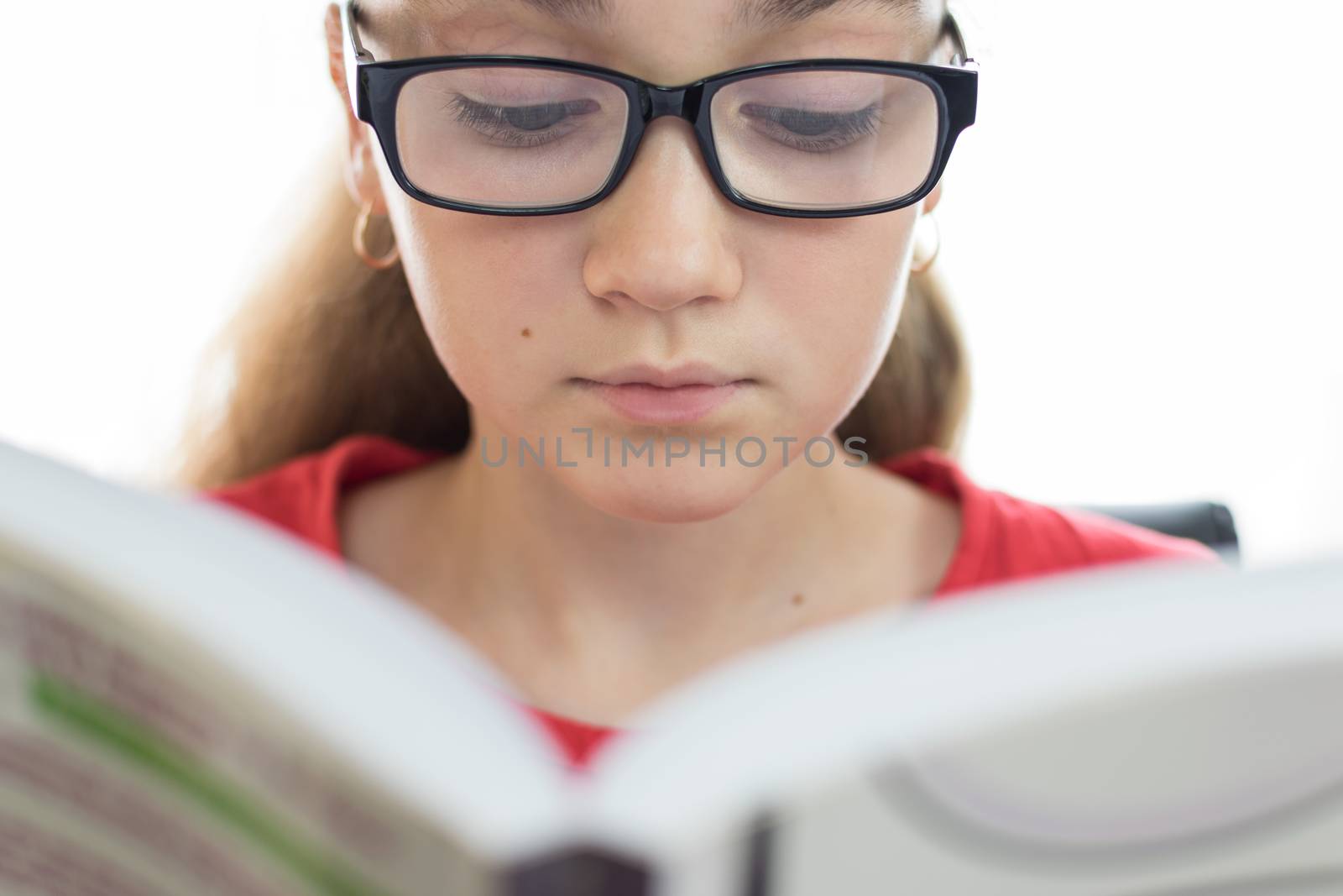 Young student reading a book by wdnet_studio