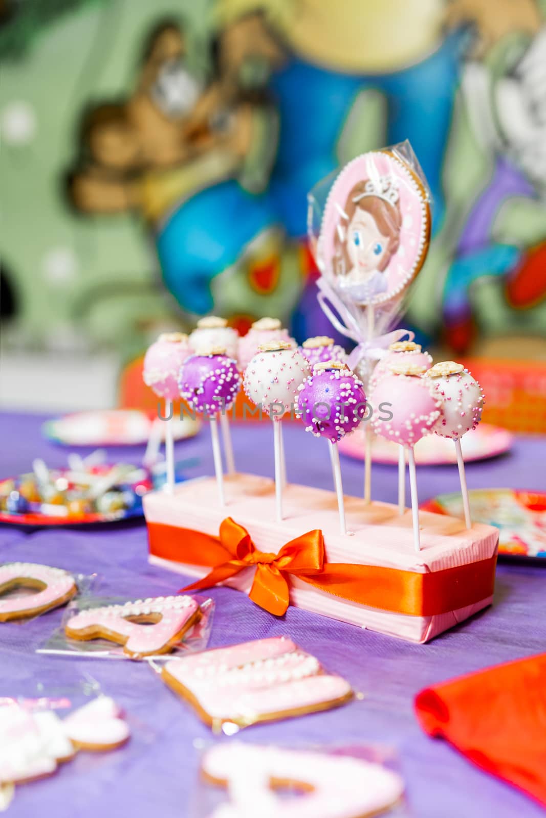 Candy bar on child birthday party. Decorated table with colorful cake pops for the guests.