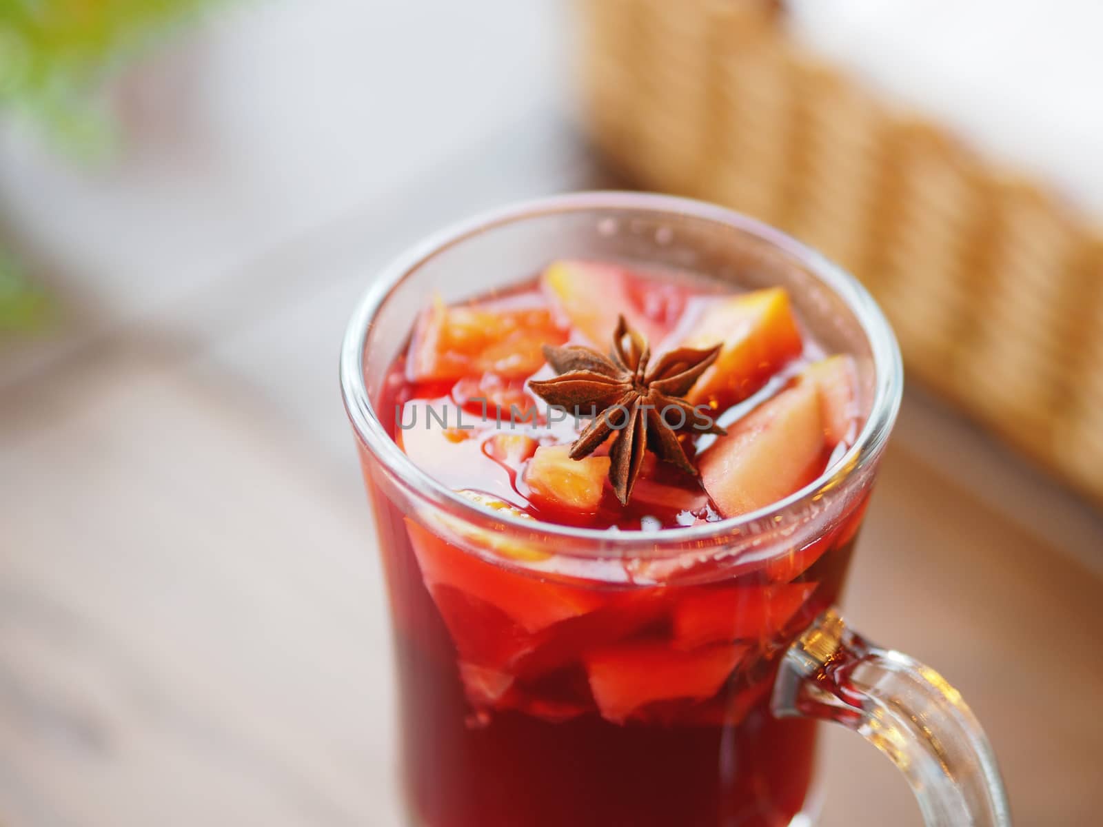 Glass of mulled wine with grapefruit, orange crusts and star anise or illicium seeds. Warming drink with or without alcohol.