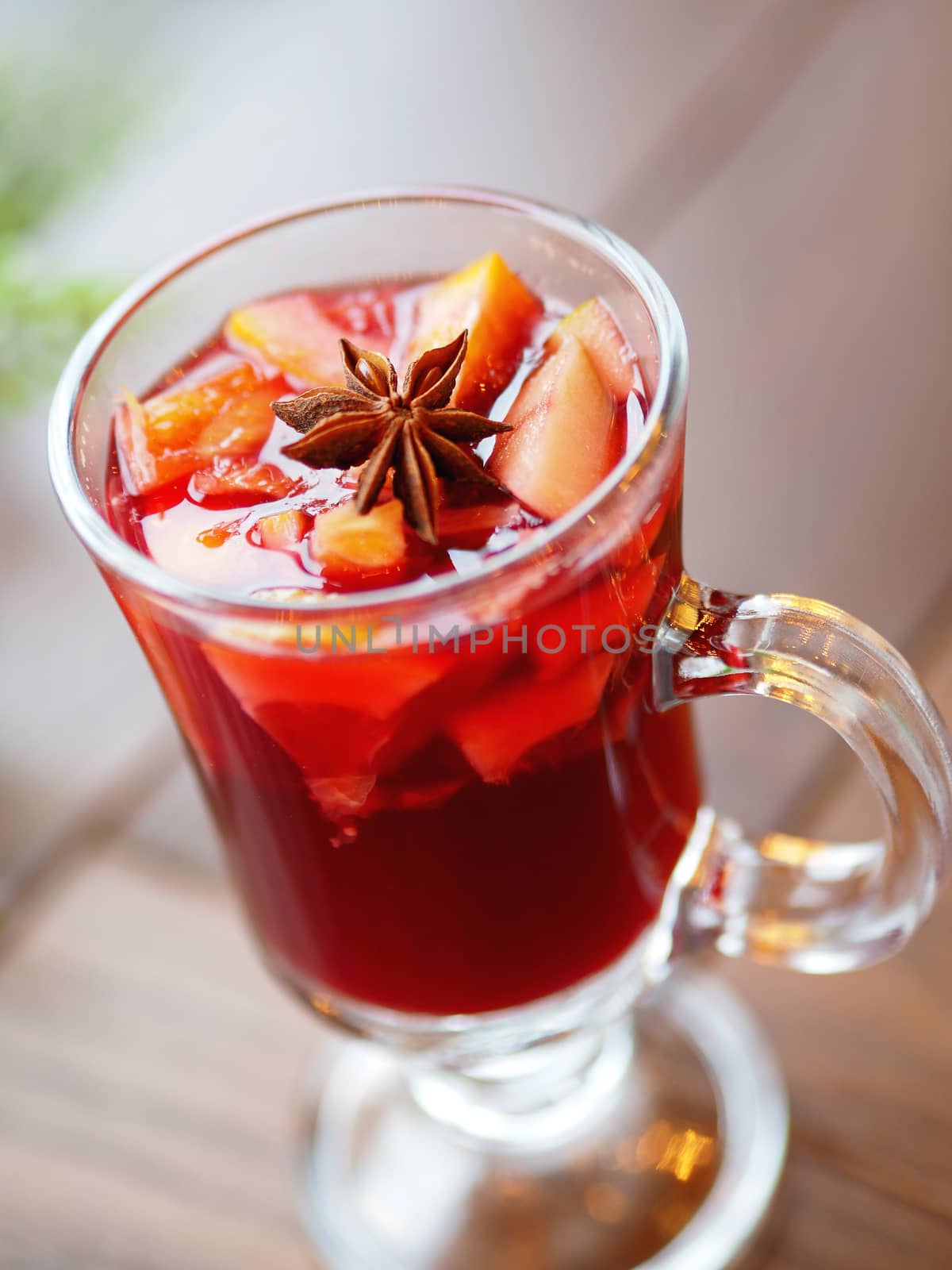 Glass of mulled wine with grapefruit, orange crusts and star anise or illicium seeds. Warming drink with or without alcohol.