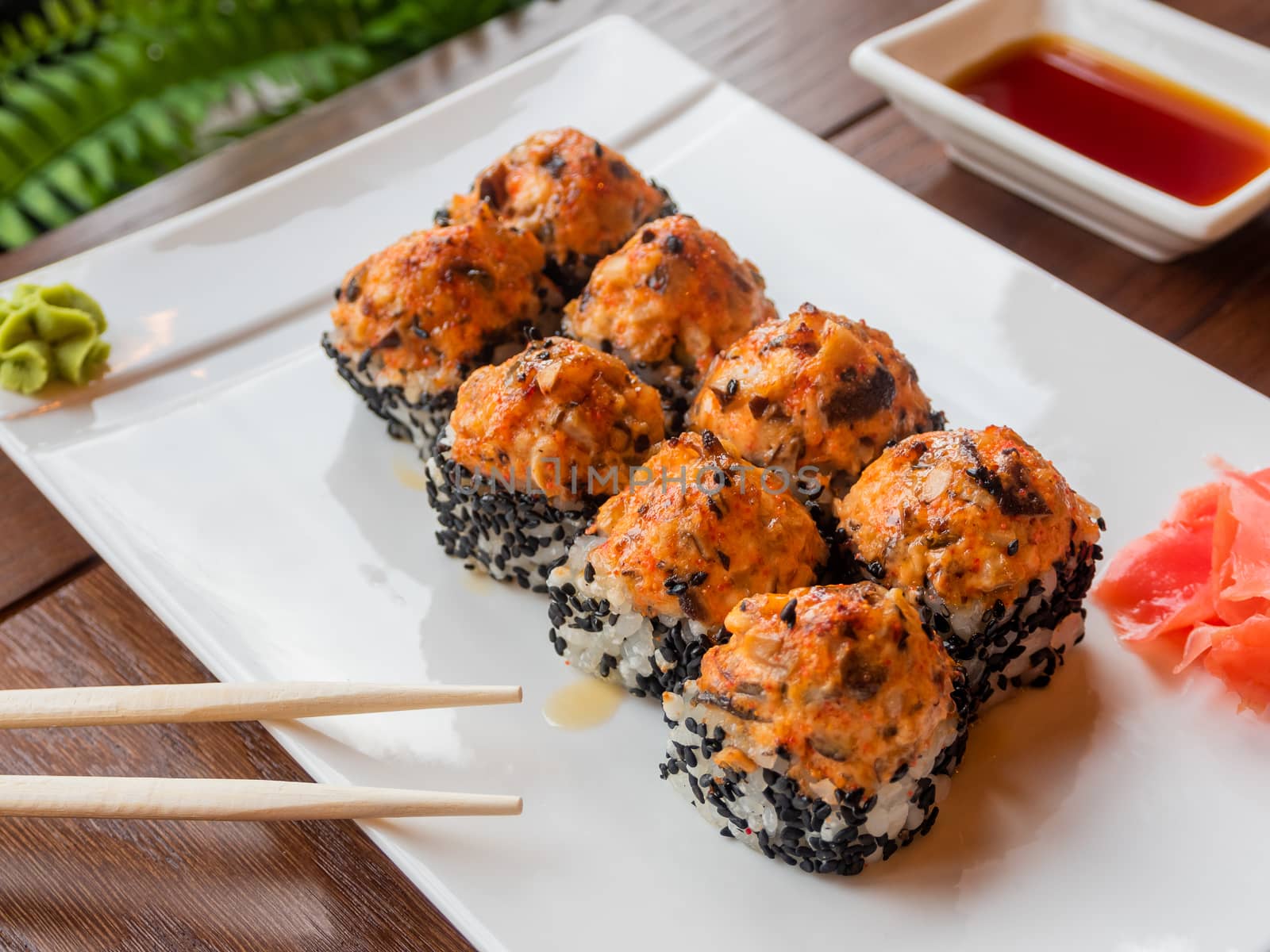 Rolls with eel, shiitake mushrooms, black sesame, spicy sauce, unagi sauce, pickled ginger. Asian cuisine, traditional dish - sushi.