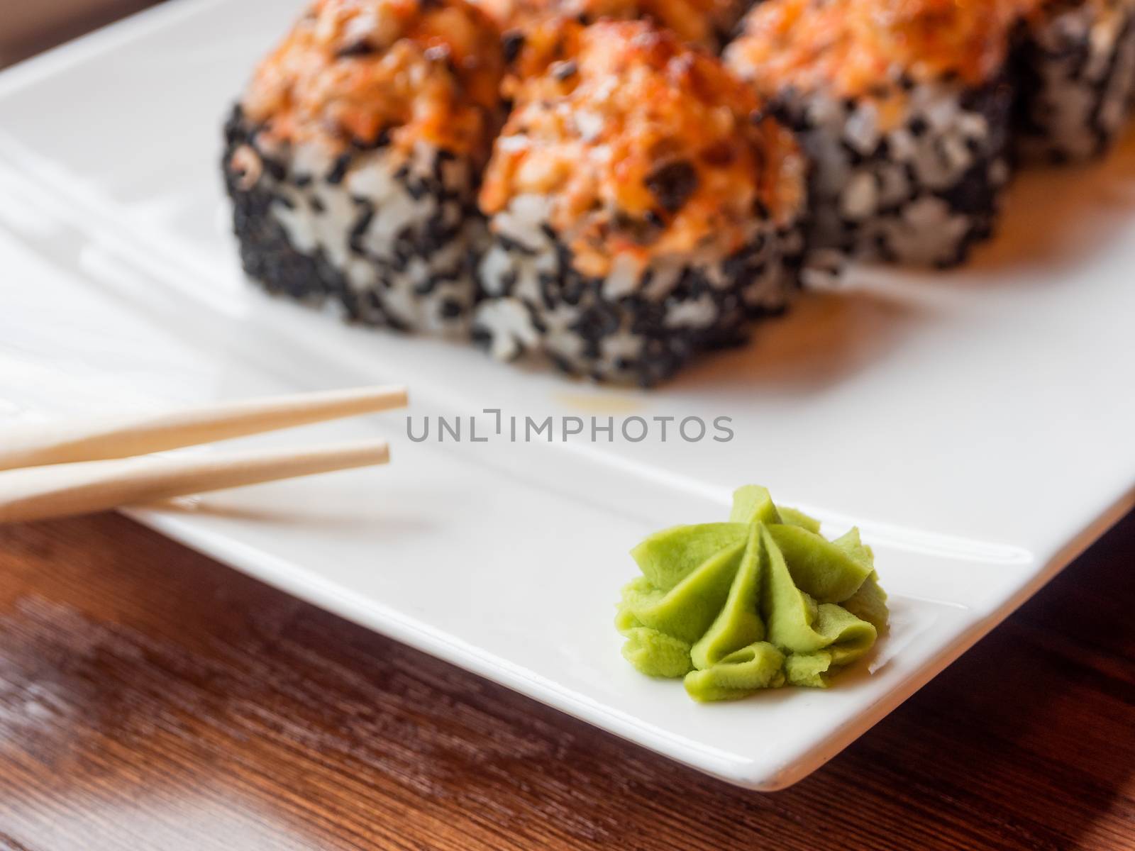 Wasabi sauce and rolls with eel, shiitake mushrooms, black sesame, spicy sauce. Asian cuisine, traditional dish - sushi.