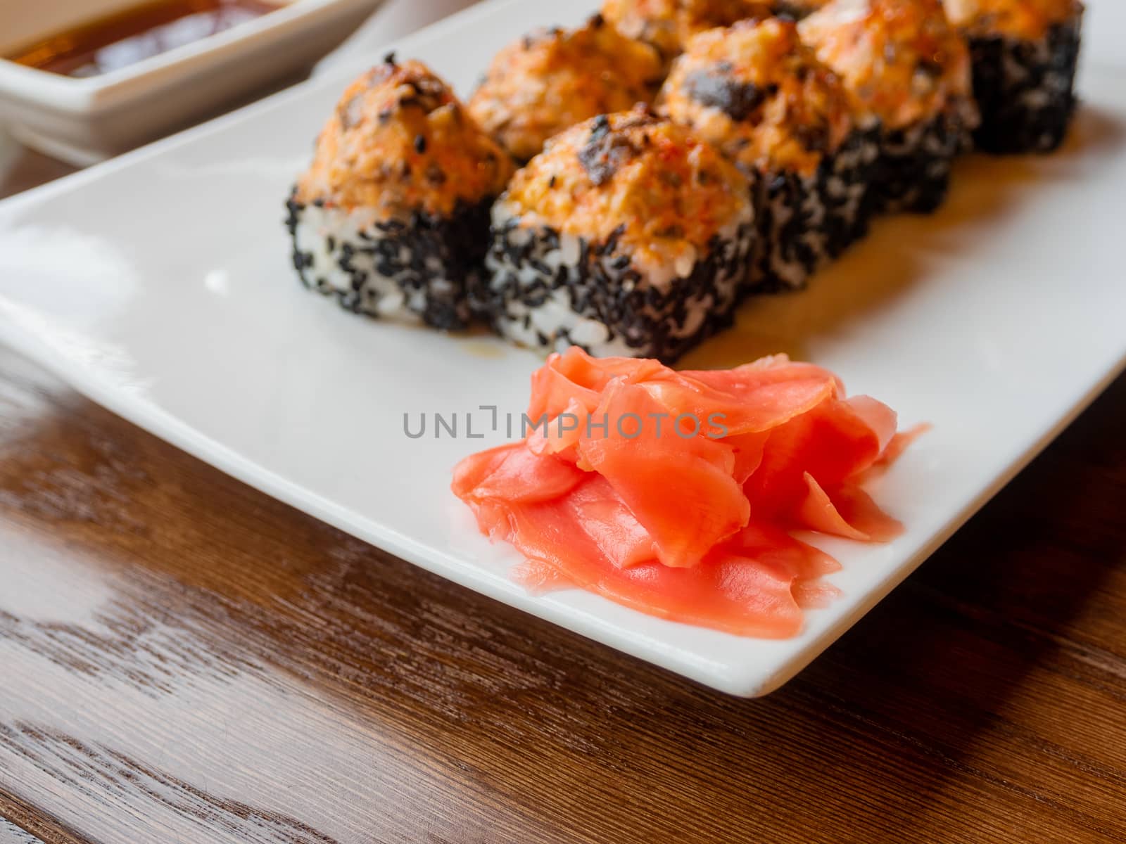 Pickled ginger and rolls with eel, shiitake mushrooms, black sesame, spicy sauce, unagi sauce. Asian cuisine, traditional dish - sushi.
