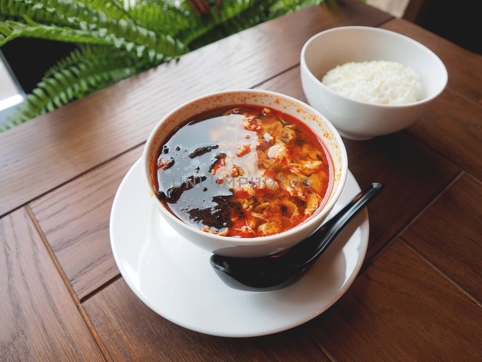 Asian cuisine - Kimchi soup in white bowl with rice. Close up photo.